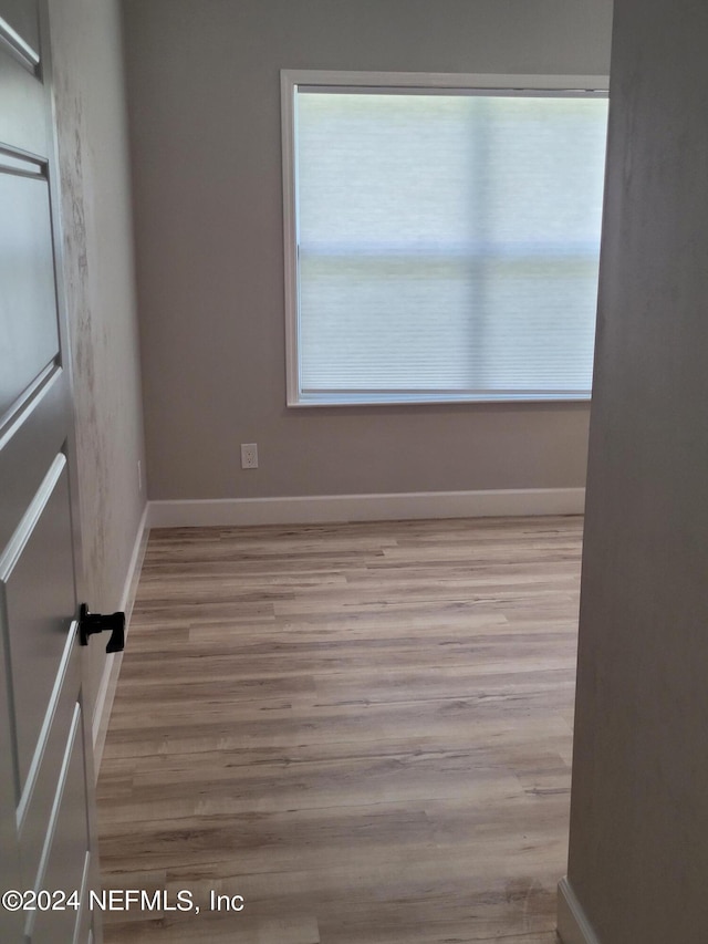 empty room featuring plenty of natural light and light hardwood / wood-style flooring