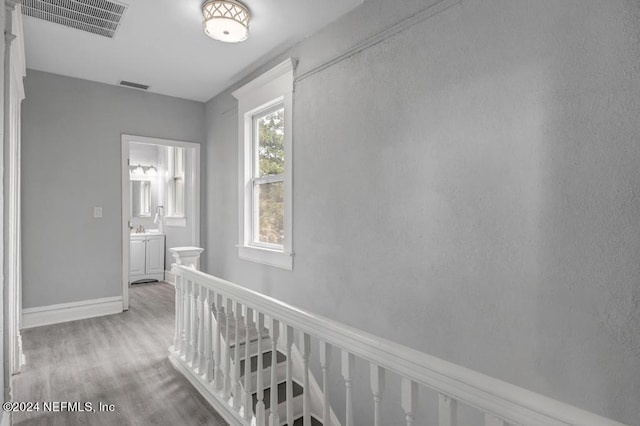 hallway with light hardwood / wood-style flooring