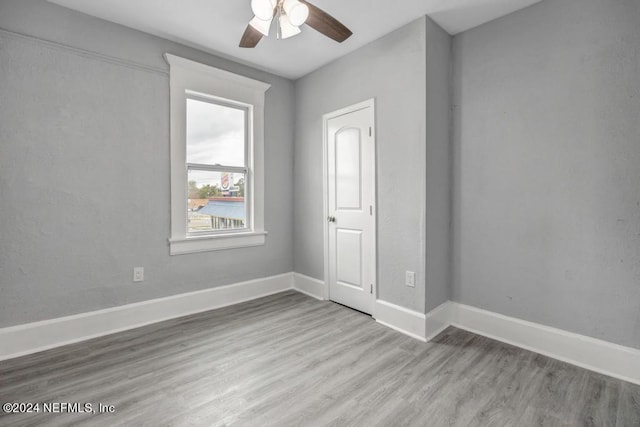 unfurnished room with ceiling fan and light hardwood / wood-style flooring