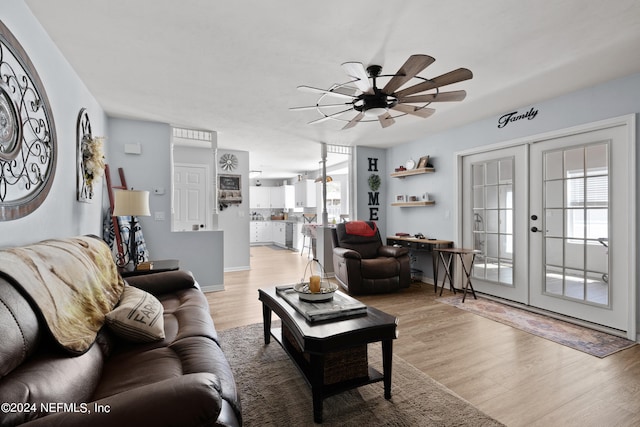 living room with light hardwood / wood-style flooring, ceiling fan, french doors, and a wealth of natural light