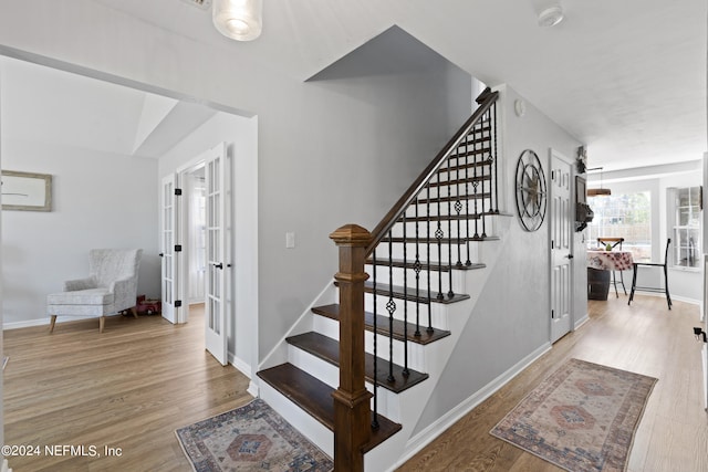 stairs with light wood-type flooring