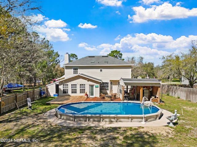 view of pool with a yard and a wooden deck