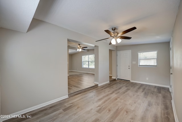 unfurnished room with ceiling fan and light wood-type flooring