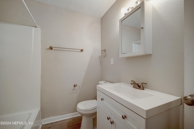 full bathroom with toilet, bathtub / shower combination, a textured ceiling, vanity, and wood-type flooring