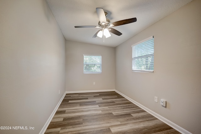 spare room featuring dark hardwood / wood-style floors and ceiling fan