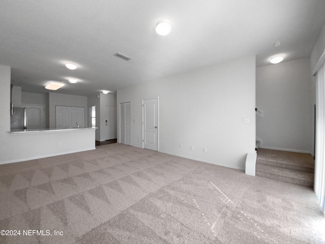 spare room featuring light colored carpet