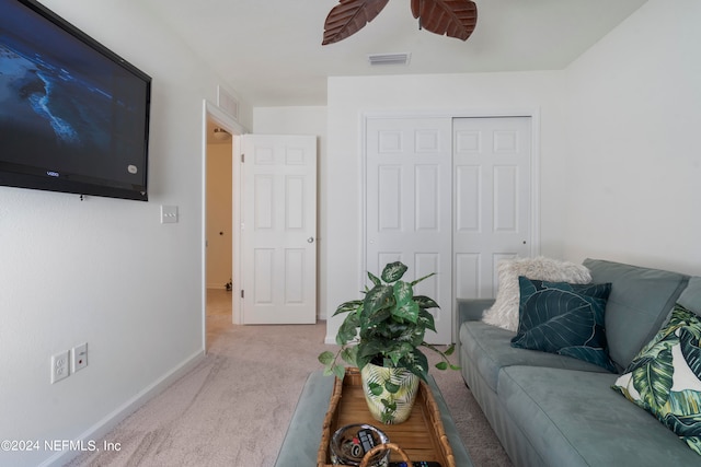 living area with baseboards, carpet, visible vents, and a ceiling fan