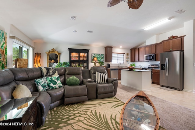 living room with lofted ceiling, visible vents, and a ceiling fan