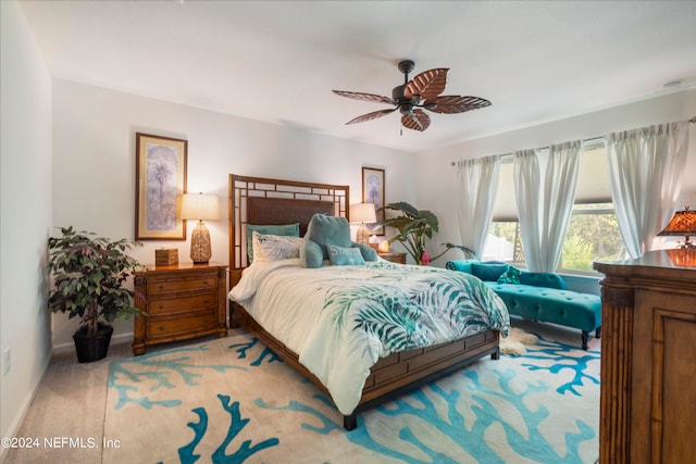 carpeted bedroom featuring a ceiling fan and baseboards