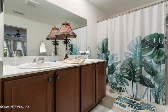 bathroom featuring double vanity, a sink, and visible vents