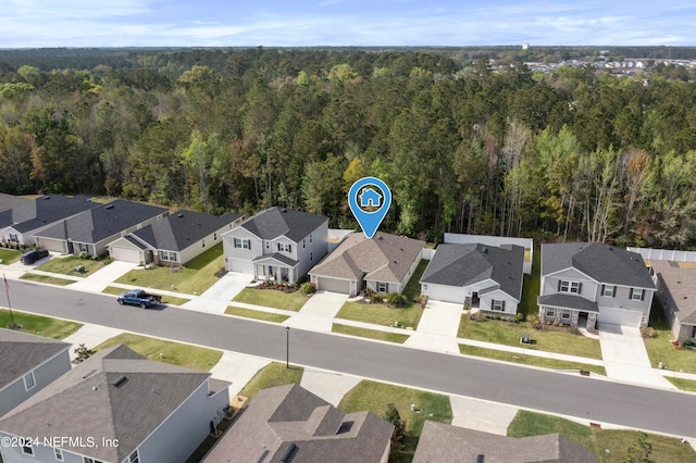 aerial view featuring a residential view and a forest view