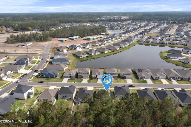 birds eye view of property featuring a water view and a residential view