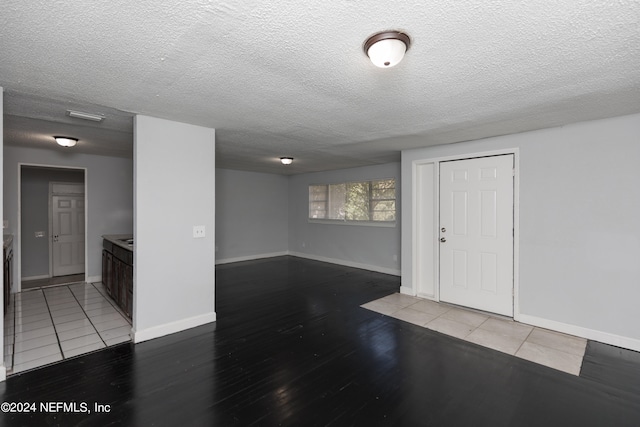 interior space featuring a textured ceiling and light wood-type flooring