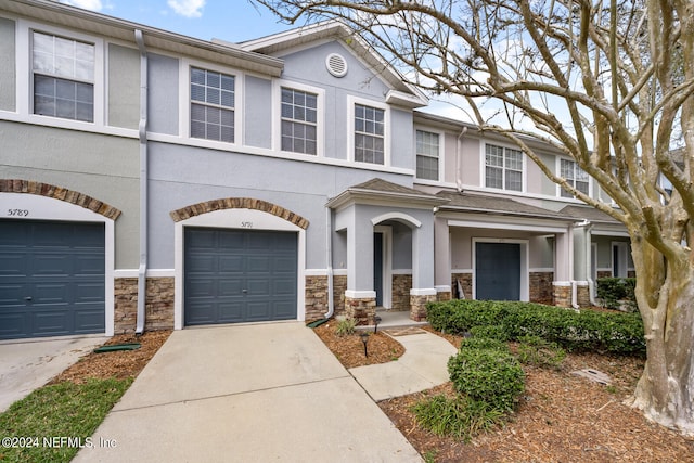 townhome / multi-family property featuring a garage