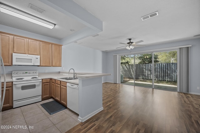 kitchen featuring white appliances, sink, light hardwood / wood-style flooring, ceiling fan, and kitchen peninsula