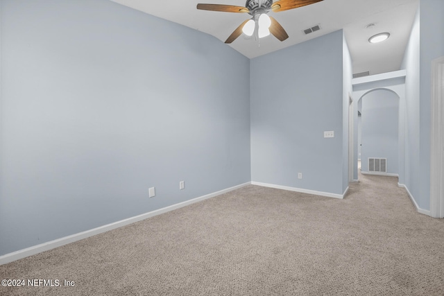 spare room featuring light carpet and ceiling fan