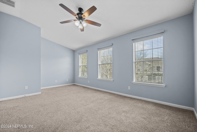 carpeted spare room with ceiling fan and lofted ceiling