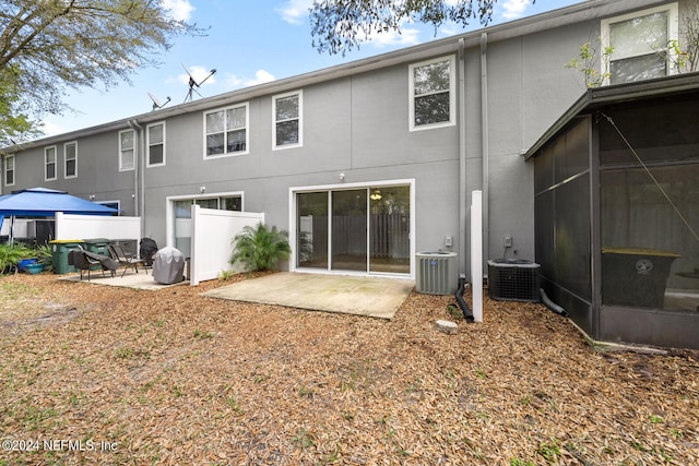 back of house with a sunroom, central air condition unit, and a patio