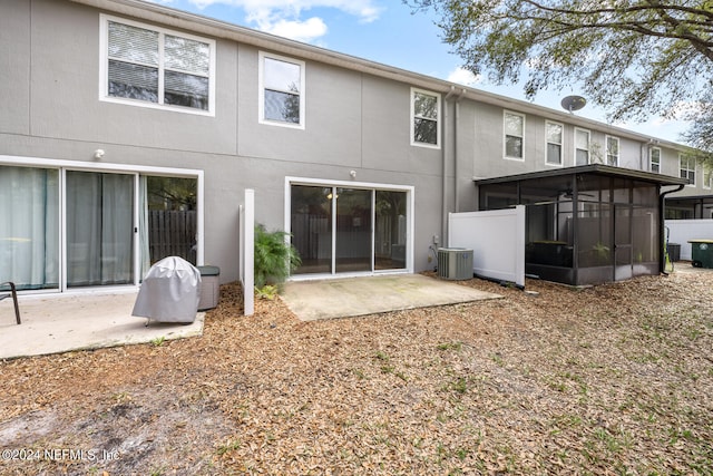 rear view of house with a patio, central air condition unit, and a sunroom