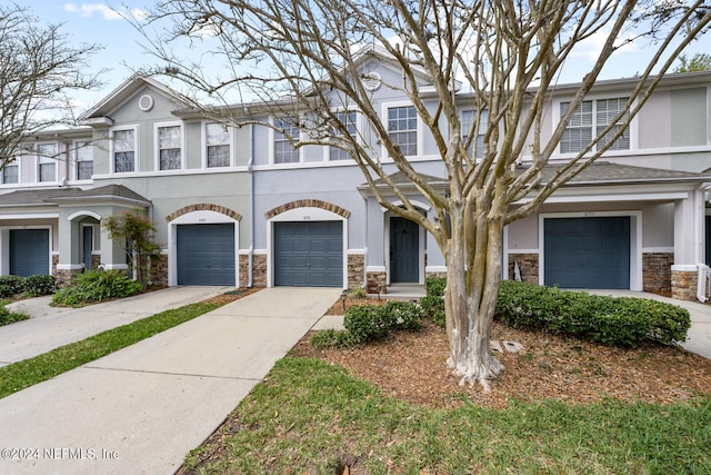 multi unit property featuring a garage