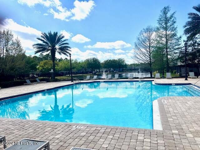 view of swimming pool featuring a patio area