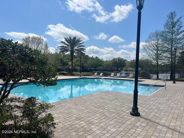 view of swimming pool with a patio