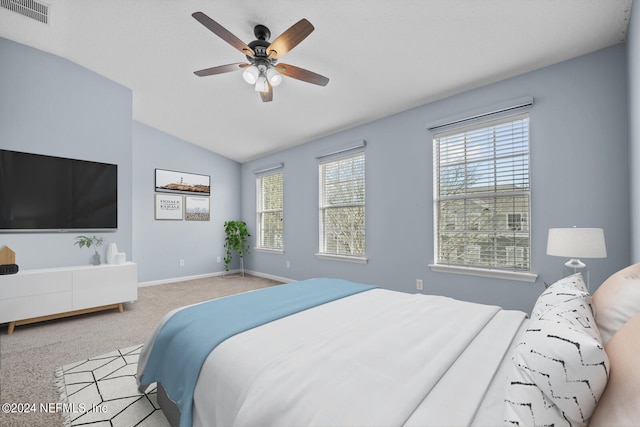 carpeted bedroom with vaulted ceiling and ceiling fan