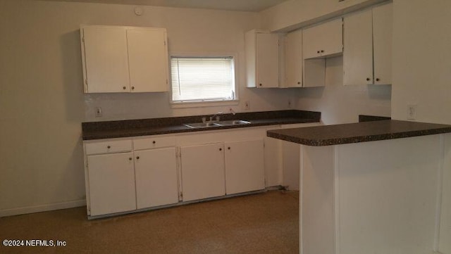 kitchen with white cabinetry and sink