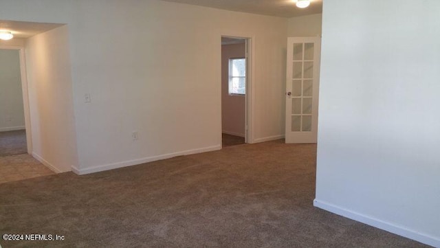 empty room featuring dark tile floors