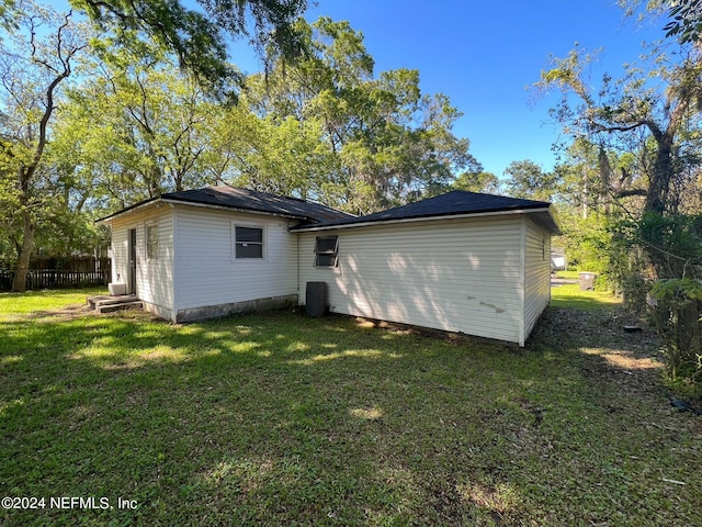 back of property featuring a lawn