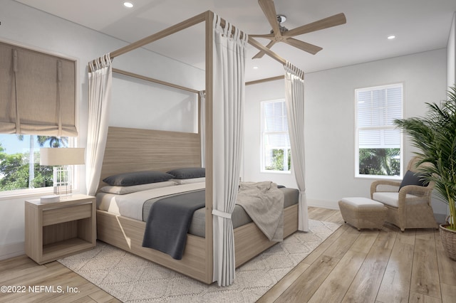 bedroom with multiple windows, ceiling fan, and light hardwood / wood-style flooring