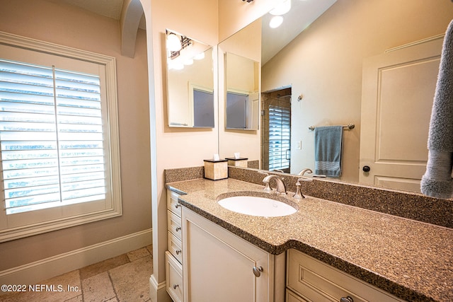 bathroom featuring vanity and vaulted ceiling