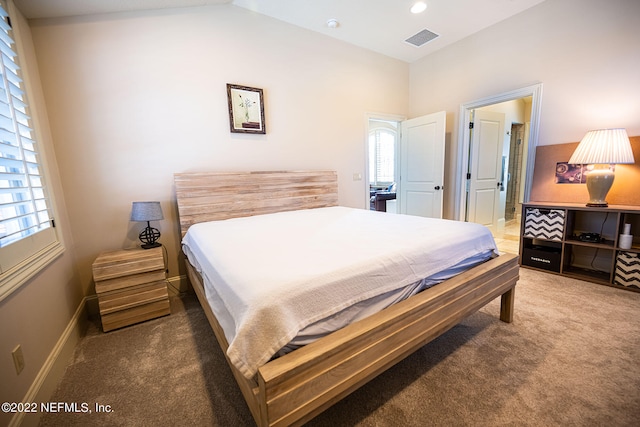 carpeted bedroom featuring lofted ceiling