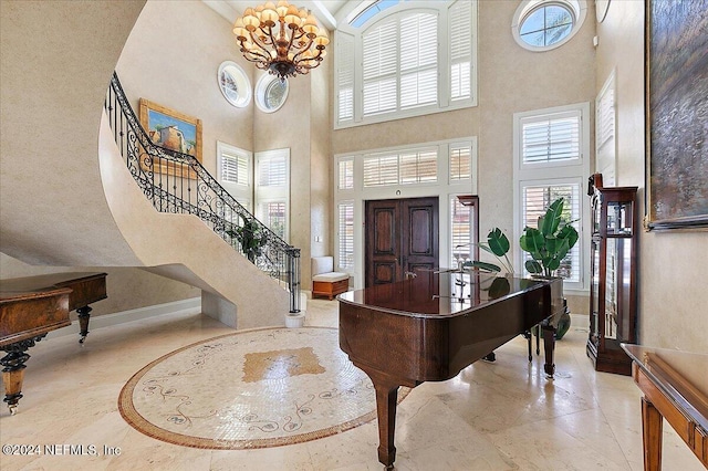 entryway featuring a notable chandelier and a high ceiling