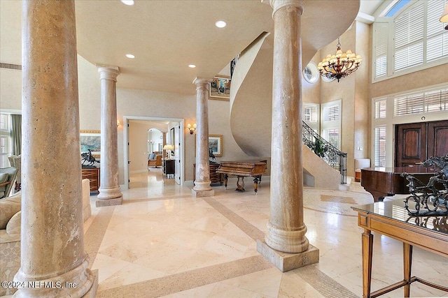1201 Ponte Vedra Blvd, Ponte Vedra Beach, FL 32082 - entryway with decorative columns, stairway, an inviting chandelier, a high ceiling, and recessed lighting