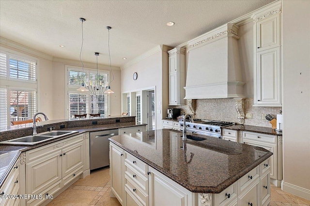 kitchen featuring pendant lighting, a kitchen island with sink, sink, ornamental molding, and stainless steel dishwasher