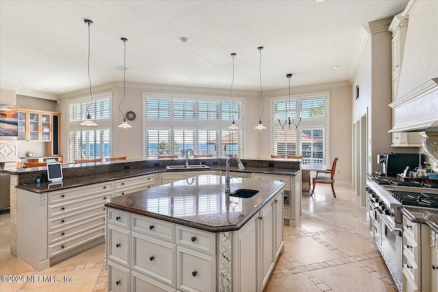 1201 Ponte Vedra Blvd, Ponte Vedra Beach, FL 32082 - kitchen featuring crown molding, a center island with sink, a sink, and high end stove