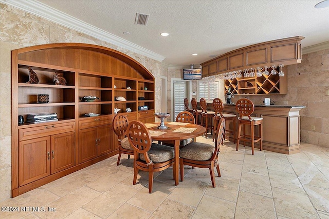 1201 Ponte Vedra Blvd, Ponte Vedra Beach, FL 32082 - dining space with visible vents, ornamental molding, stone tile flooring, a textured ceiling, and a bar