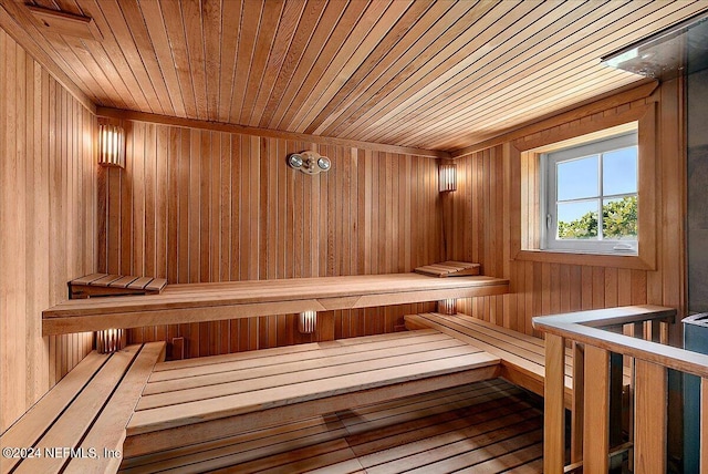 view of sauna / steam room with hardwood / wood-style flooring, wood ceiling, and wood walls