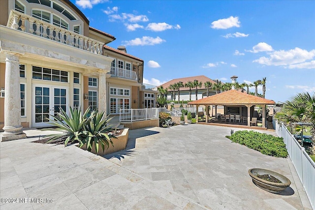 exterior space with a balcony, a patio area, and a gazebo