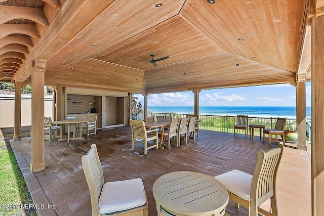 wooden terrace featuring a water view