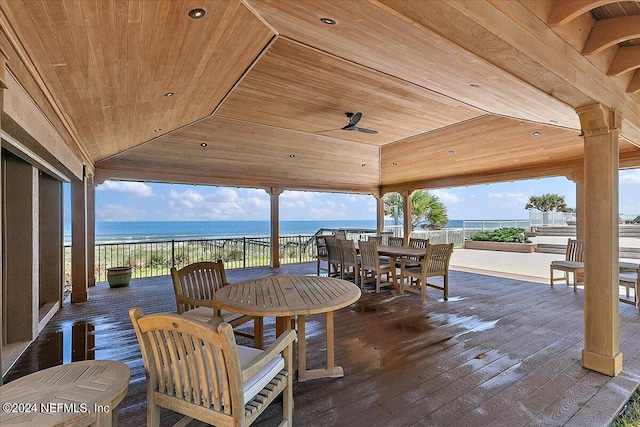 view of patio featuring ceiling fan and a deck with water view