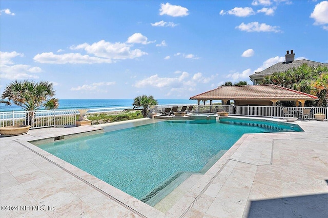 1201 Ponte Vedra Blvd, Ponte Vedra Beach, FL 32082 - view of pool featuring fence, a patio, a water view, and a pool with connected hot tub