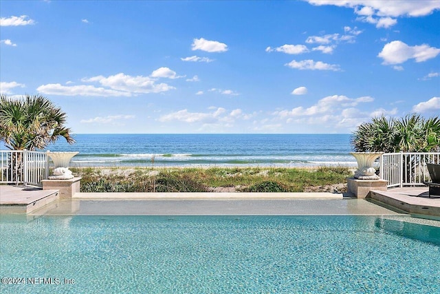 view of swimming pool featuring a water view