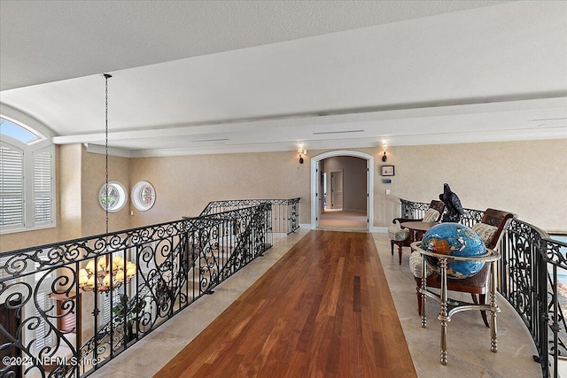 1201 Ponte Vedra Blvd, Ponte Vedra Beach, FL 32082 - hallway with arched walkways, wood finished floors, and an upstairs landing