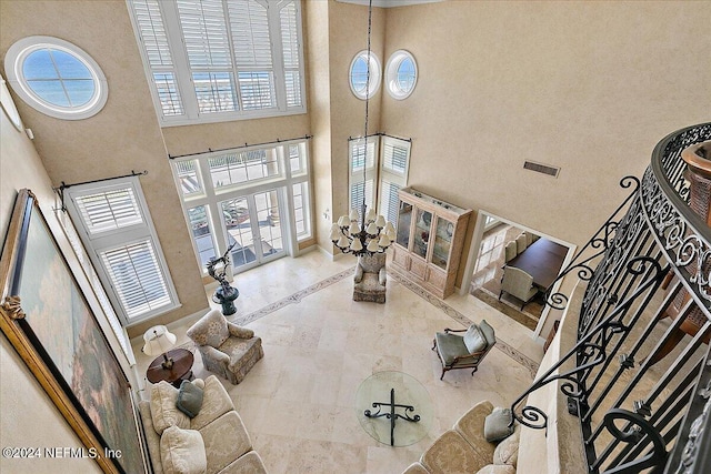 living room featuring a high ceiling and french doors