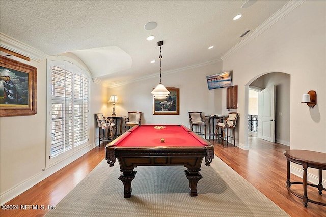 recreation room featuring light wood-type flooring, pool table, a textured ceiling, vaulted ceiling, and ornamental molding