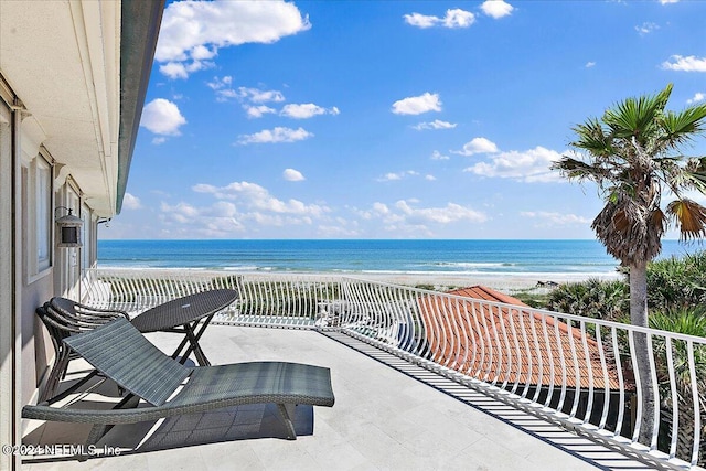 balcony with a beach view and a water view