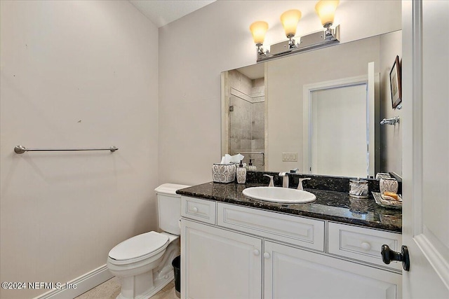 bathroom featuring walk in shower, vanity, and toilet