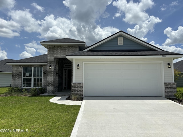 view of front of house featuring a garage and a front yard